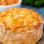 Close up individual corned beef and potato pie wrapped in shortcrust pastry.