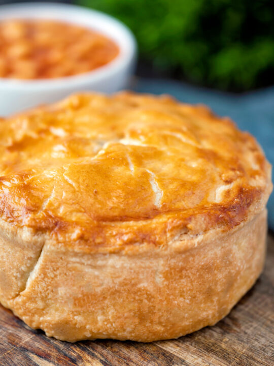 Close up individual corned beef and potato pie wrapped in shortcrust pastry.