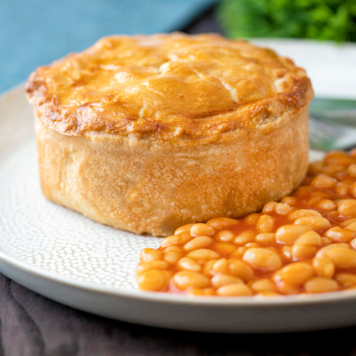 Corned beef and potato pie wrapped in shortcrust pastry served with baked beans.