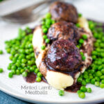 Minted lamb meatballs with red wine gravy served with mashed potato and peas featuring a title overlay.