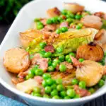 Petit pois a la Francaise or French braised peas and lettuce with bacon and onions featuring a title ovelay.