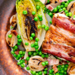Petit pois a la Francaise or French braised peas and lettuce with bacon and pearl onions featuring a title overlay.
