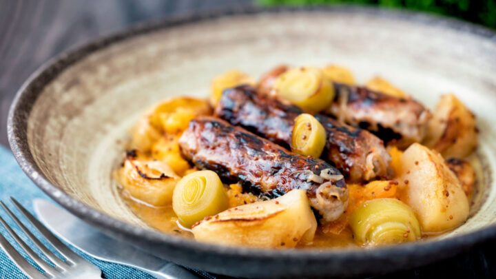 Sausage and apple casserole with leeks, mustard and cider sauce and swede and carrot mash.