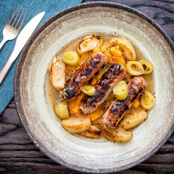 Sausage and apple casserole with leeks, mustard and cider sauce and swede and carrot mash.