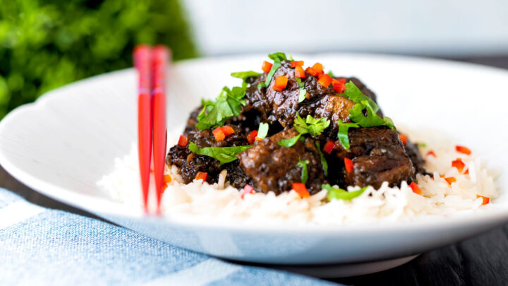 Babi chin, Indonesian soy sauce braised pork belly served with rice, coriander and chilli.