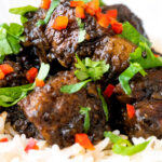 Close up babi chin Indonesian soy sauce braised pork belly served with coriander and chilli.