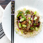Overhead black pepper beef stir fry with green pepper and red onion.