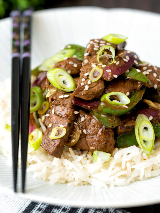 Black pepper beef stir fry with green pepper and red onion.