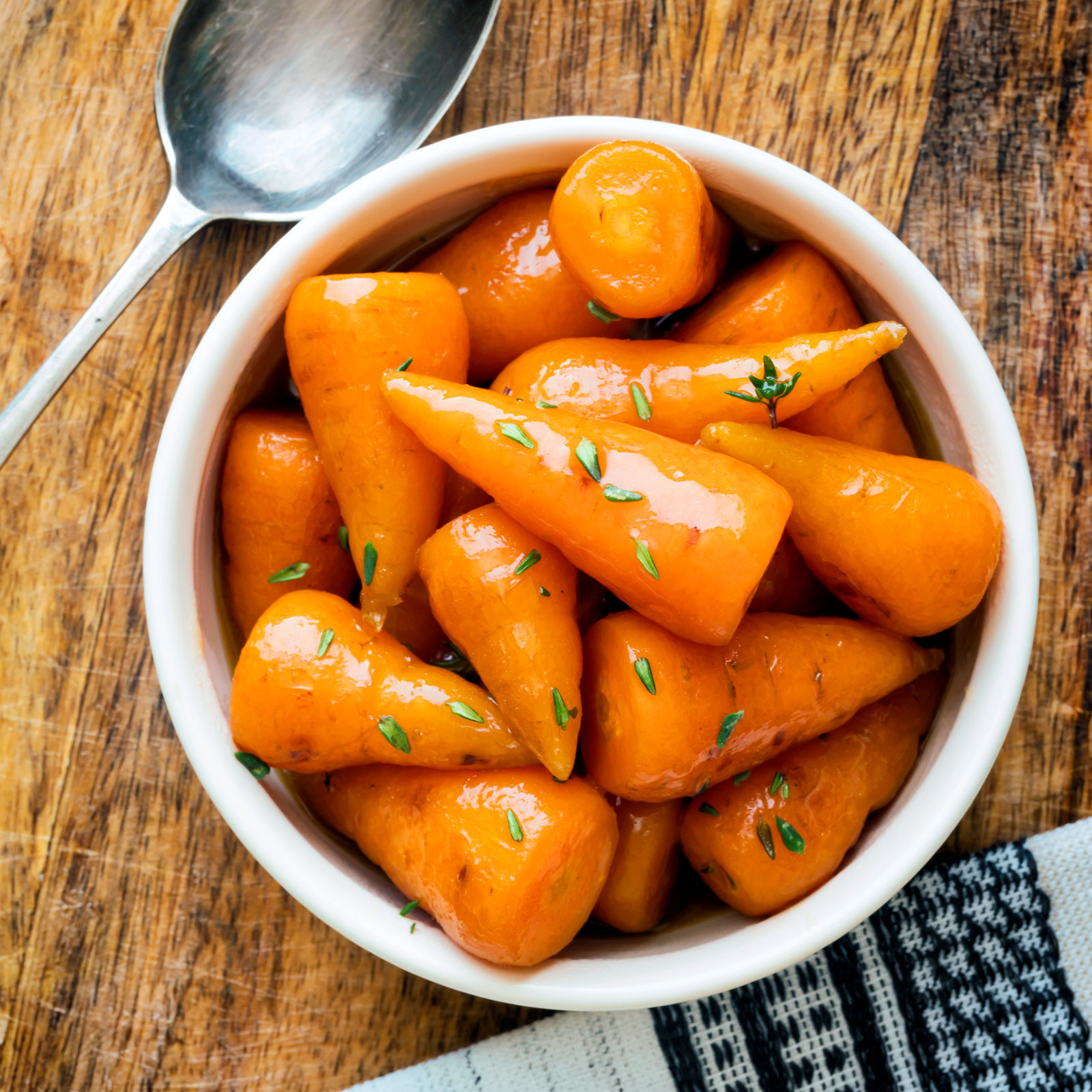 Brown sugar and butter glazed Chantenay baby carrots with fresh thyme.