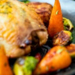 Close up brown sugar and butter glazed Chantenay carrots with fresh thyme.