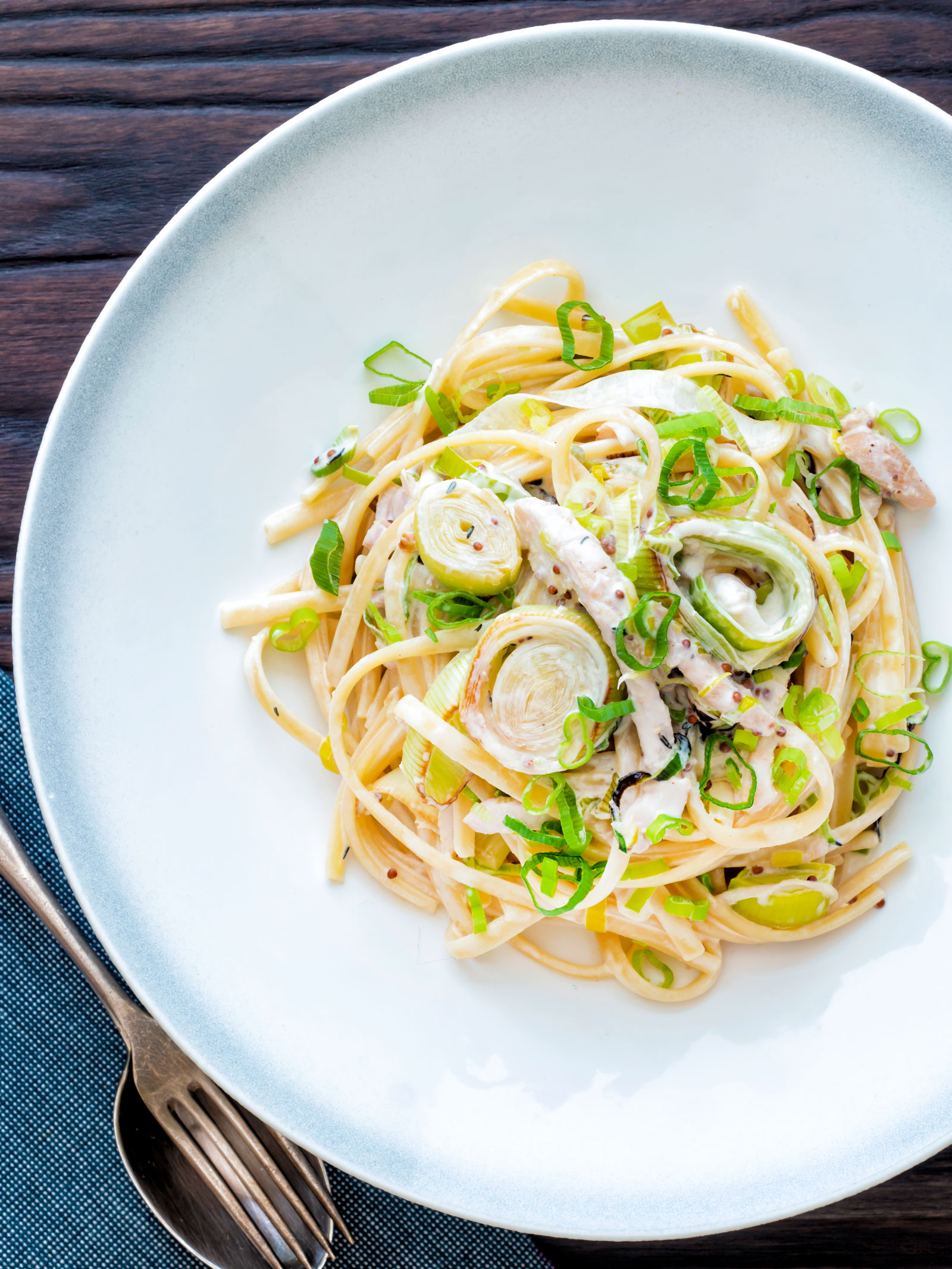 Overhead chicken and leek pasta with linguini in a mustard and creme fraiche sauce.