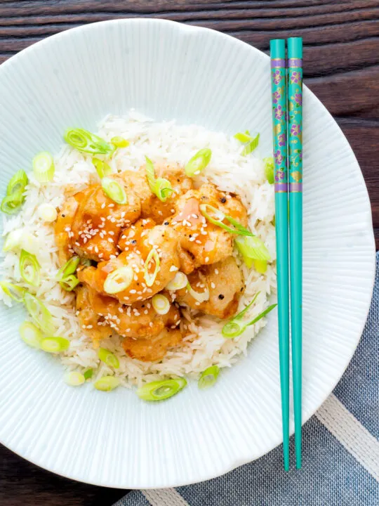 Over head Chinese crispy lemon chicken served with rice.