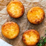 Overhead fondant potatoes poached in butter and stock with a sprig of thyme.