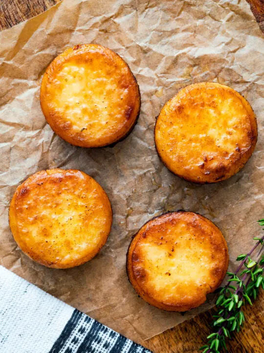 Overhead fondant potatoes poached in butter and stock with a sprig of thyme.