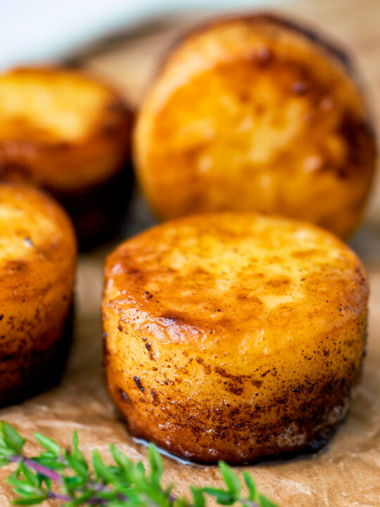 Fondant potatoes poached in butter and stock with a sprig of thyme.