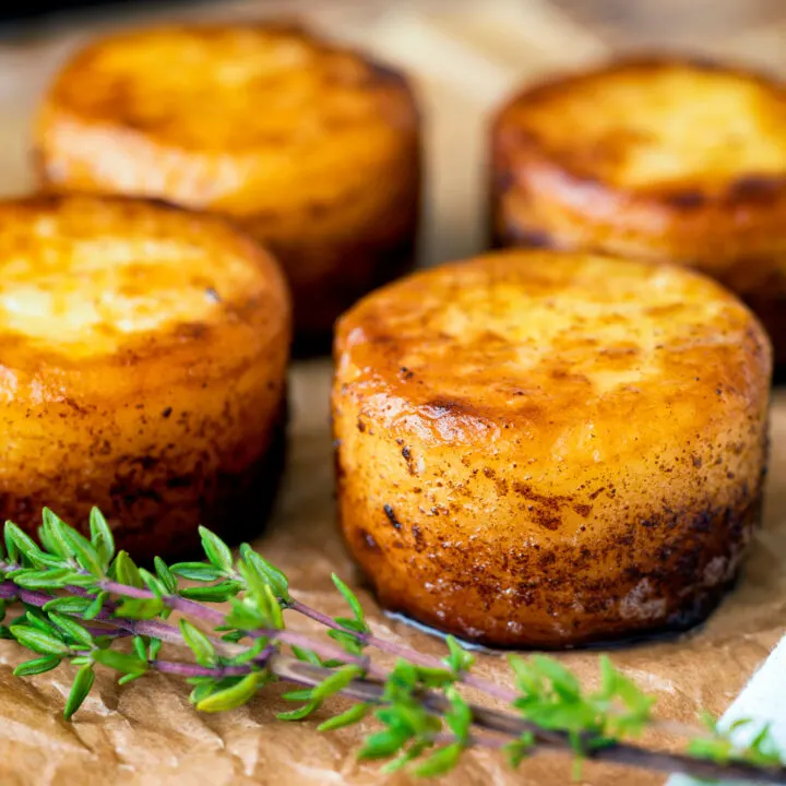 Easy fondant potatoes poached in butter and stock with a sprig of thyme.