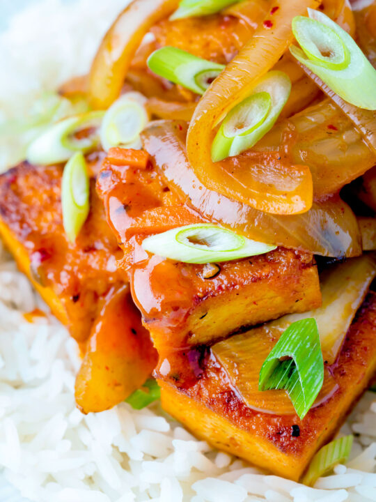 Close up Korean gochujang tofu stew with kimchi served with white rice.