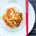 Overhead Korean gochujang tofu stew with kimchi served with white rice featuring a title overlay.