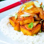 Vegan gochujang tofu stew with kimchi served with white rice.