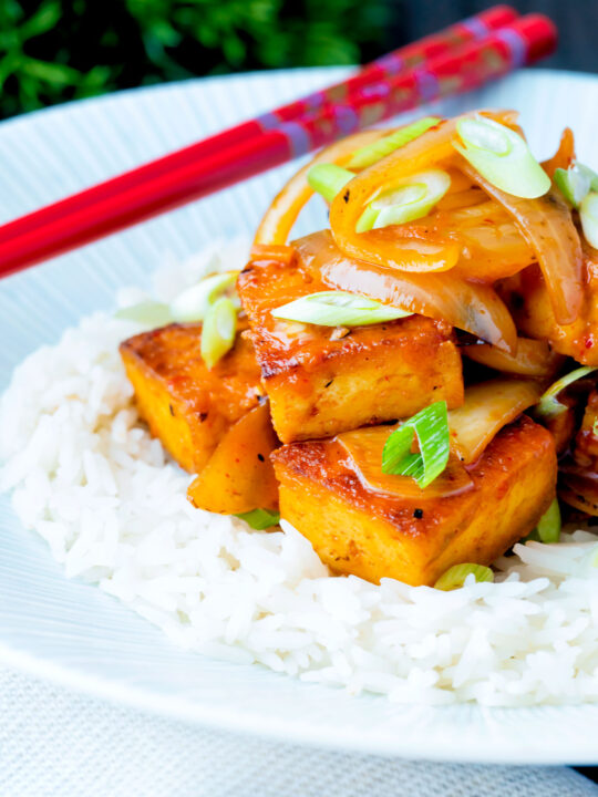 Vegan gochujang tofu stew with kimchi served with white rice.