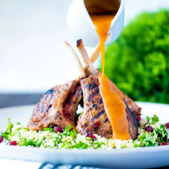 Harissa lamb chops served on herby buttered couscous with a spicy sauce.