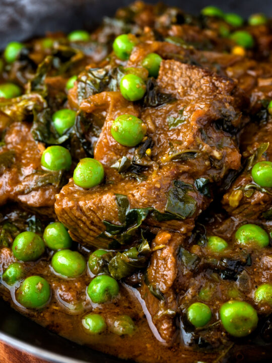 Close up methi gosht (beef and fenugreek) curry with peas.