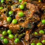 Close up methi gosht (beef and fenugreek) curry with peas featuring a title overlay.