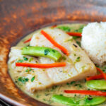 Close up Thai green fish curry made with cod and sugar snap peas.