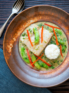Overhead Thai green fish curry made with cod and sugar snap peas.