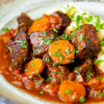 Moshari kokkinisto a Greek beef and tomato stew served with celeriac mash featuring a title overlay.