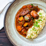 Overhead Moshari kokkinisto a Greek beef and tomato stew served with celeriac mash.