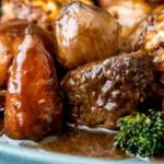 Close up British beef and ale stew with dumplings, carrots and potatoes featuring a title overlay.