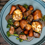 Overhead British beef and ale stew with dumplings, carrots and potatoes featuring a title overlay.