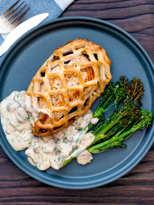 Overhead Chicken en croute with a mushroom cream sauce and roasted tenderstem broccoli.