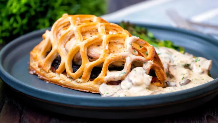 Chicken en croute served with a mushroom cream sauce and roasted tenderstem broccoli.
