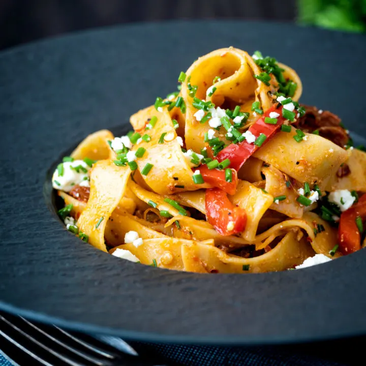 Harissa pappardelle pasta with with roasted peppers, feta cheese and snipped chives.