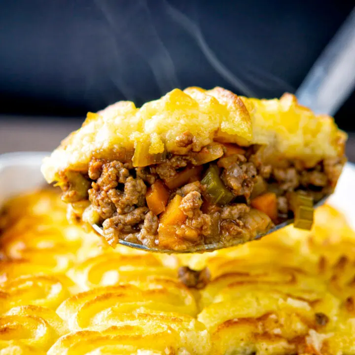 Close up steaming hot portion of lamb shepherds pie taken from the pie dish.