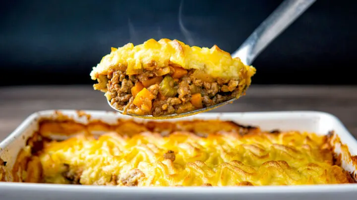 Steaming hot portion of lamb shepherds pie taken from the pie dish.