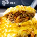 Steaming hot portion of lamb shepherds pie on a spoon featuring a title overlay.