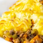 Minced lamb shepherds pie served in a white bowl.