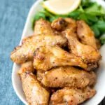 Crispy lemon pepper chicken wings served with a green salad.