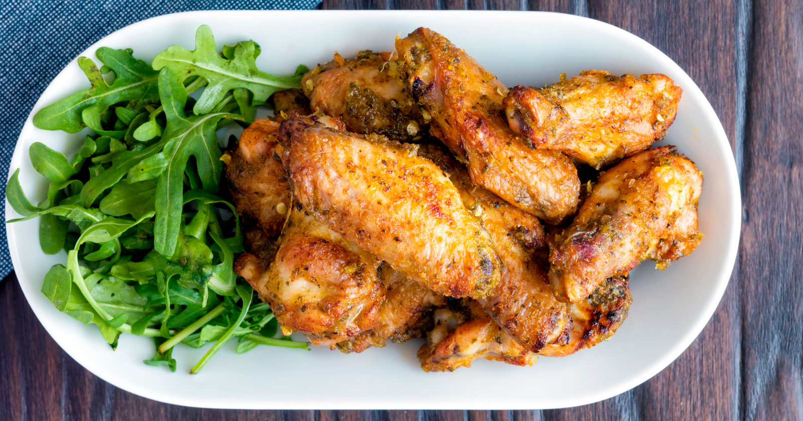 Pineapple and jalapeno pepper glazed chicken wings served with arugula.