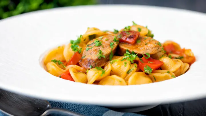 Sausage and pepper pasta in a light tomato sauce with fresh parsley.