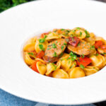 Sausage and pepper orecchiette pasta in a light tomato sauce with fresh parsley.