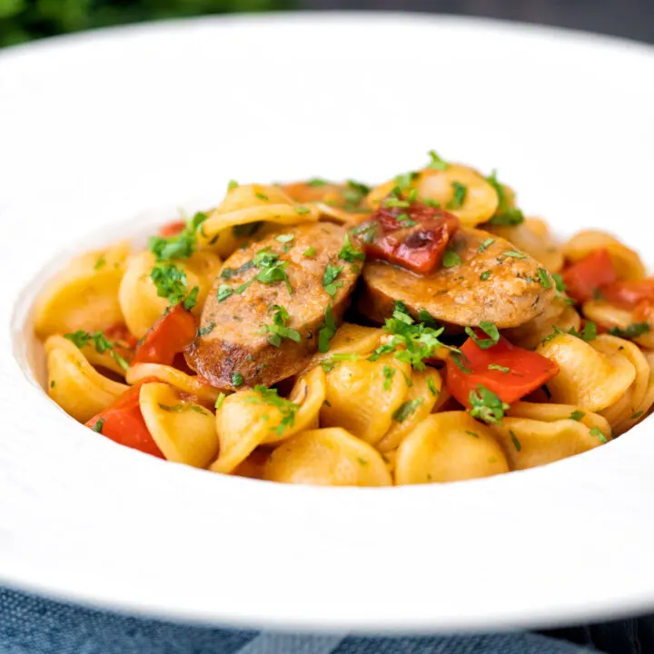 Sausage and pepper pasta in a light tomato sauce with fresh parsley.