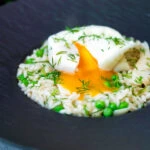 Smoked haddock risotto with peas topped with a poached egg and fresh dill.