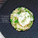 Overhead smoked haddock risotto with peas topped with a poached egg and fresh dill featuring a title overlay.