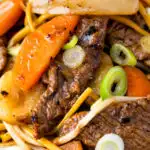 Close up homemade Chinese beef chow mein fakeaway featuring a title overlay.