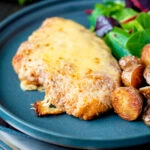 Grilled chicken parmo cheese topped breaded chicken escalope served with fried potatoes.