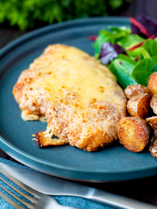 Grilled chicken parmo cheese topped breaded chicken escalope served with fried potatoes.